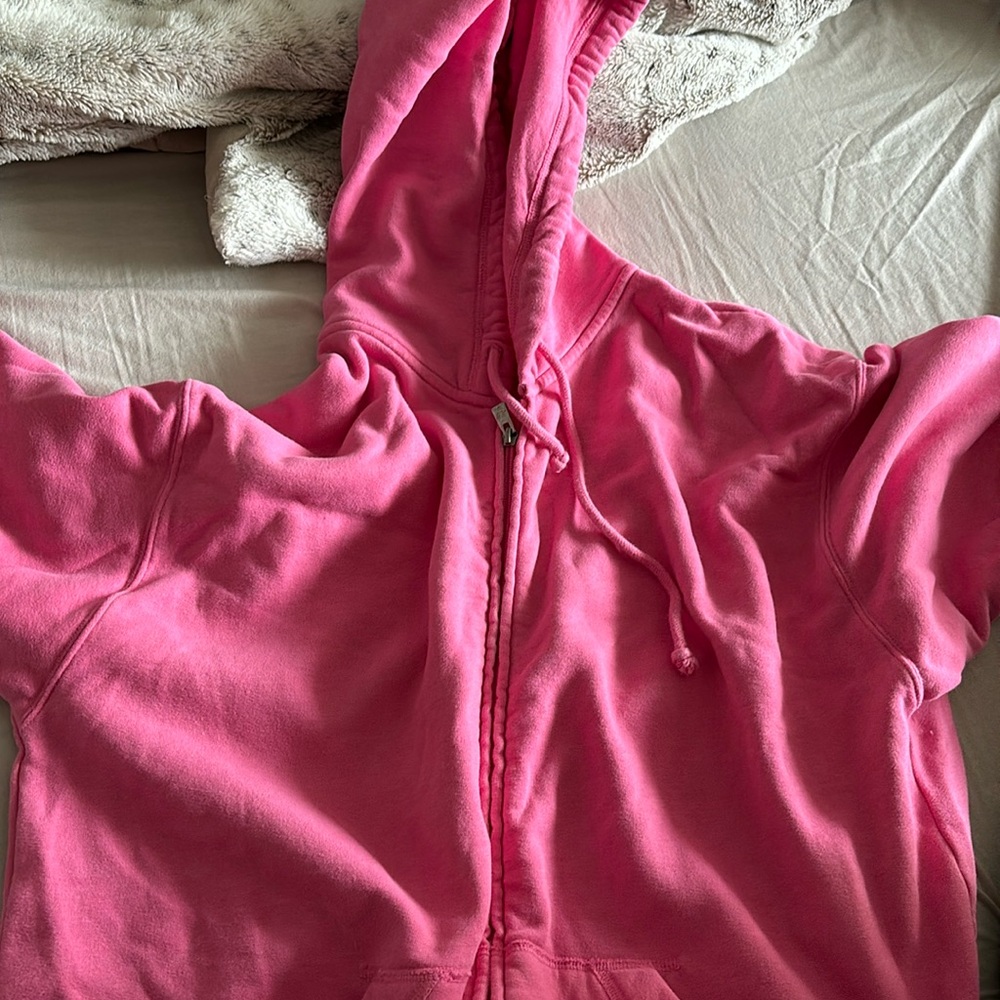 selling a pink over sized zip up from hollsiter in size medium